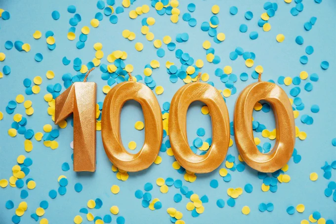 Image shows the number 1000 in gold surrounded by confetti