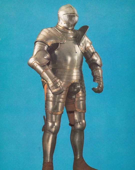The plate armour of Henry VIII from circa 1540 against a bright blue background. EPH302