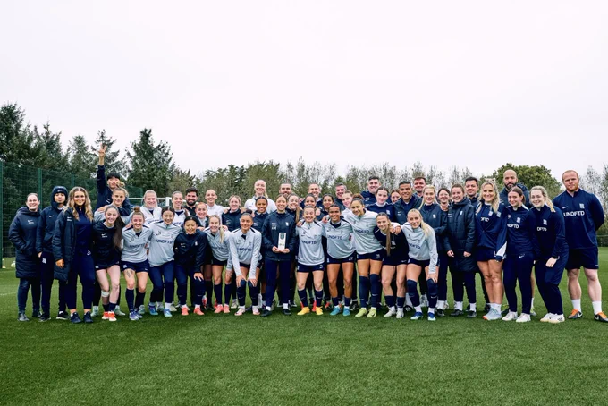 The team have a picture with Amy Merricks for Manager of the Month.