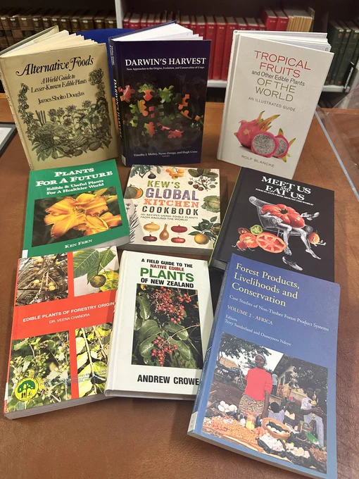 Nine books laid out on the table all with a botanical theme. 