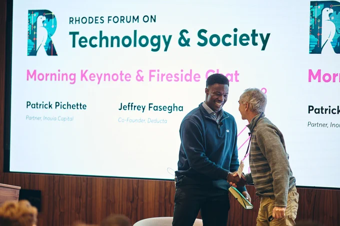Jeffrey Fasegha shakes hands with Patrick Pichette
