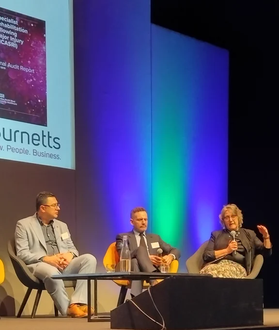 Paul Brown, Dr Mike Dilley and Dr Krystyna Walton on stage.