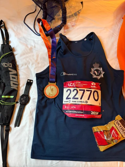 Gary's dark blue running vest, with his runner number attached, and the medal he received for completing the New York Marathon