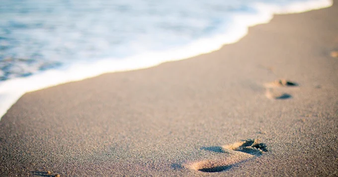 Footprints in sand banner