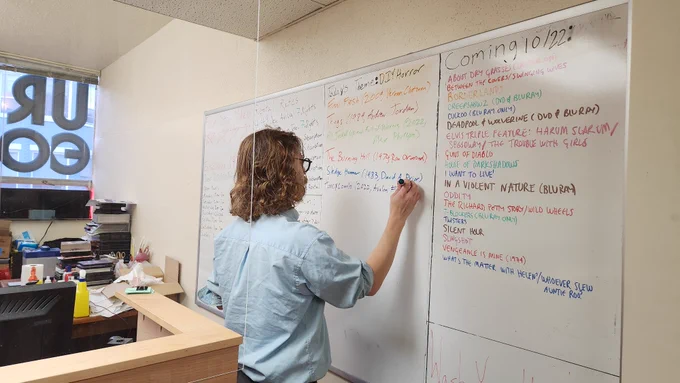 Lewis Peterson adds to his "DIY Horror" list on the whiteboard