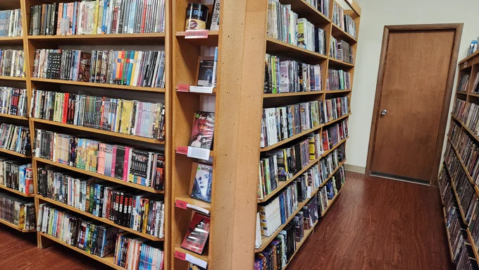 Four Star Video Rental shelves, including a vertical column of staff picks for the month of October 2024