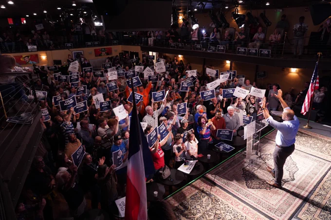 A photo of Congressman Allred waving at the crowd during a campaign event.