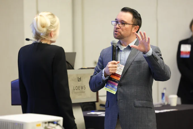 Two participants speak at QM Connect 2024.