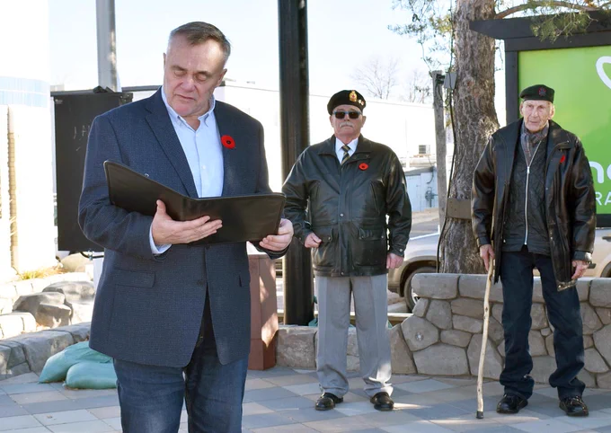 Swift Current Mayor Al Bridal delivers remarks during the flag raising ceremony, Nov. 4. Standing behind, from left, are Swift Current Legion members Dave Boucher and John Watson.
