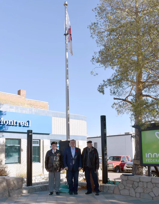Standing below the poppy flag after the raising of the flag, from left to right, Swift Current Legion past president Dave Boucher, Mayor Al Bridal, and Legion member and Second World War veteran John Watson.