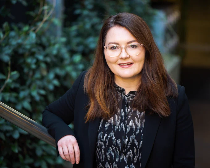 Professor Seana Gall standing outside and smiling