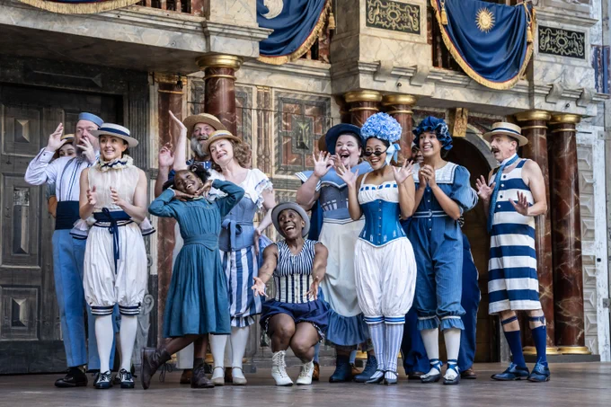 The Company of Princess Essex (2024). 

A group of actors wearing bright blue and white Edwardian costumes pose excitedly on the stage in the Globe theatre. 