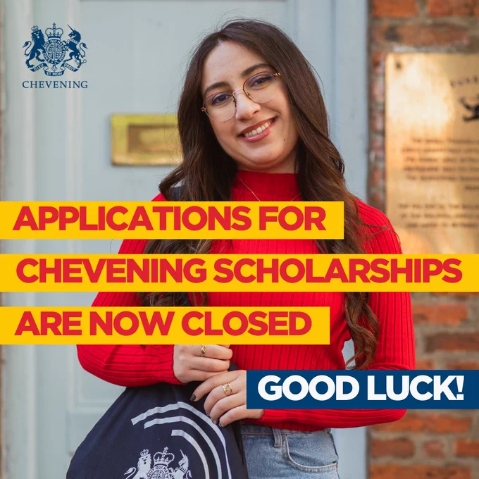 Person smiling in front of a brick wall, holding a tote bag with the Chevening logo. The image includes text that reads 'Applications for Chevening Scholarships are now closed. Good luck!'