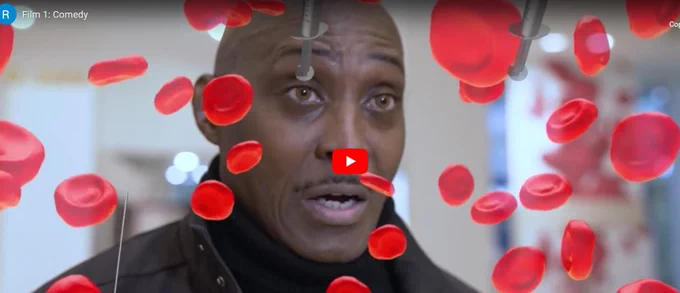 Photo of a black male looking surprised and fearful at being faced with a blood donation centre. Images of red blood cells and injections in the image.