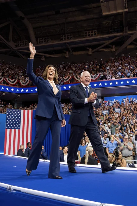 Vice President Harris and Governor Walz walking on stage.