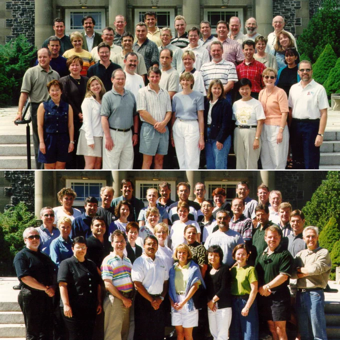 Two groups of MBA students standing on stairs and posing for a group photo.