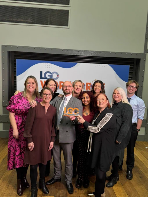 Photo of a group of Salford City Council officers with an LGC trophy