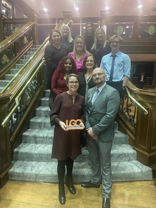 Photo of a group of Salford City Council officers with an LGC trophy