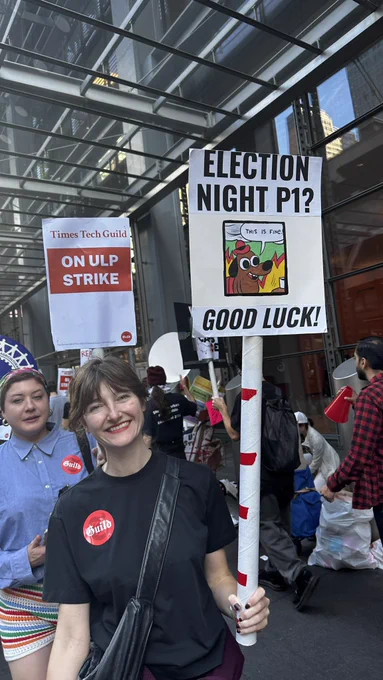 Union member holding sign that says “ELECTION NIGHT P1? GOOD LUCK!”