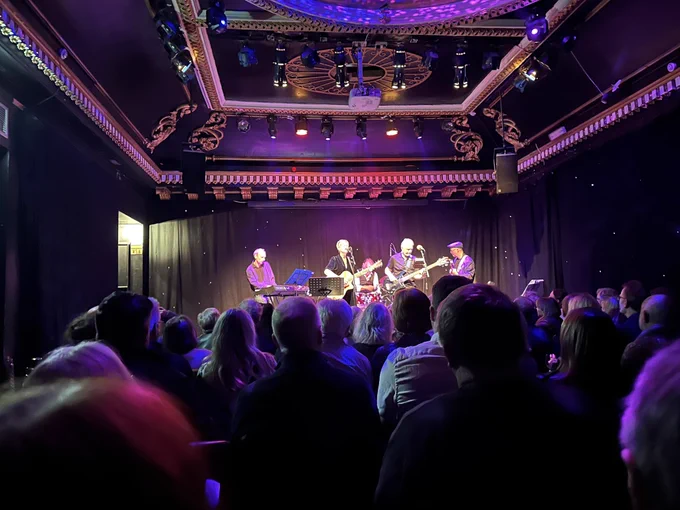 Band on stage in front of an audience