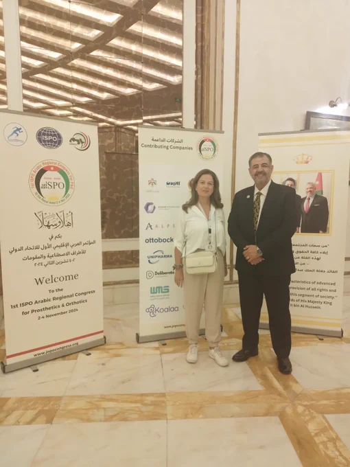 Marie is standing next to Mr Raed Al Khattab, President of the ISPO Arabic Regional Congress for Prosthetics and Orthotics.  They are standing in front of 3 Congress signs.