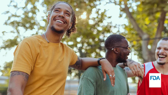 A diverse group of men laughing.