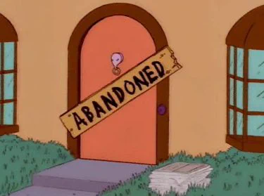 A sign on a house saying “Abandoned”