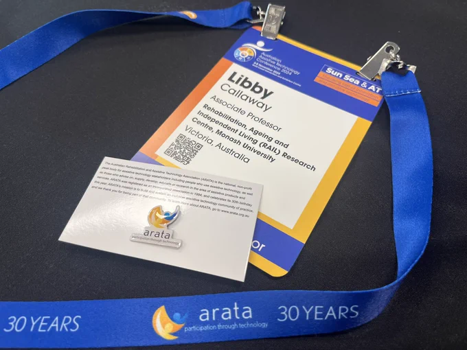 A lanyard with a name tag and a pin with the ARATA logo