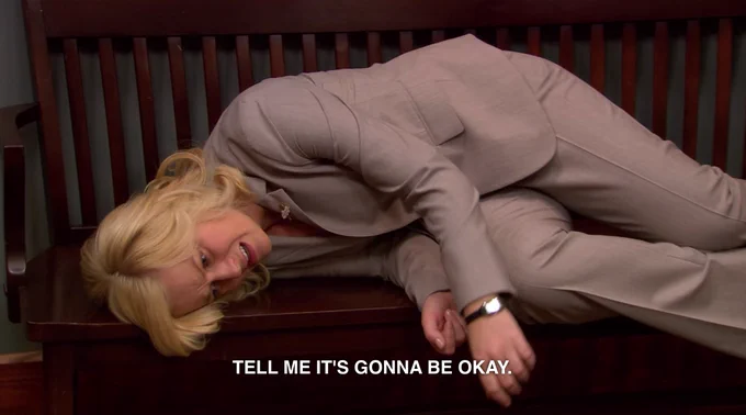 Leslie laying on a bench saying "tell me it's gonna be okay"