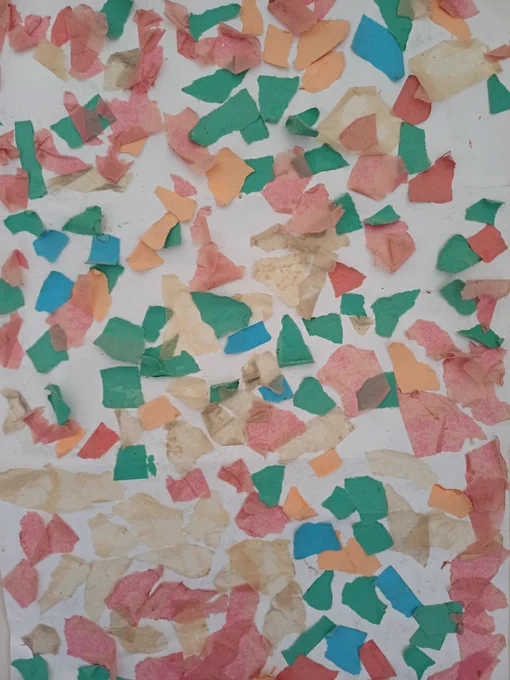 A beautiful collage made of brightly coloured tissue paper stuck on a cream background, slightly faded with age