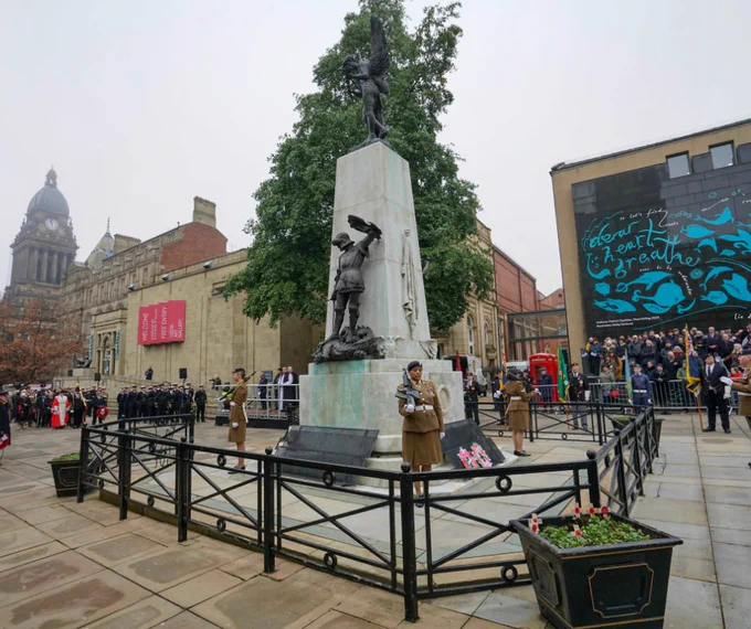 Remembrance Sunday tribute at Victoria Gardens. Servicemen and women stand in front of the war memorial.
