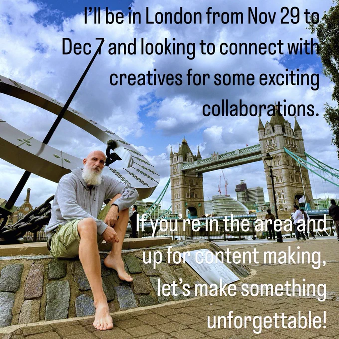 A bearded man with a bald head sits casually on a stone ledge near the iconic Tower Bridge in London, with the large metal sculpture “Timepiece” in the background. He’s dressed in a light hoodie and shorts, sitting barefoot, looking relaxed yet focused. The sky is partly cloudy, adding depth to the scene. Overlay text reads: “I’ll be in London from Nov 29 to Dec 7 and looking to connect with creatives for some exciting collaborations. If you’re in the area and up for content making, let’s make something unforgettable!”