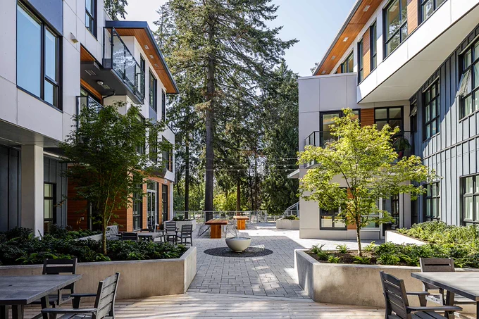 L'Arche Greater Vancouver's west-facing, park-accessible building is in ‘C-shape’, centered around a significant 20-metre-tall pine tree that was carefully maintained and protected from the original site. 