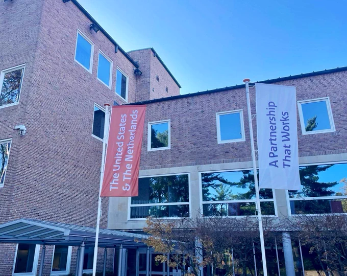 Flags outside the Dutch embassy with the slogan: The United States and The Netherlands, A partnership that works.