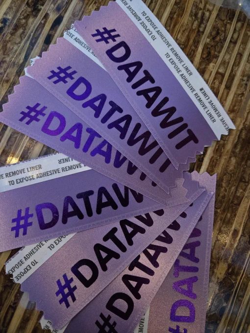 Light purple conference badge ribbons with #datawit in a dark purple font 