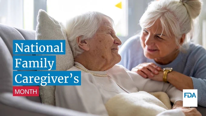 An elderly woman smiles at her caregiver. Text reads, National Family Caregivers Month.