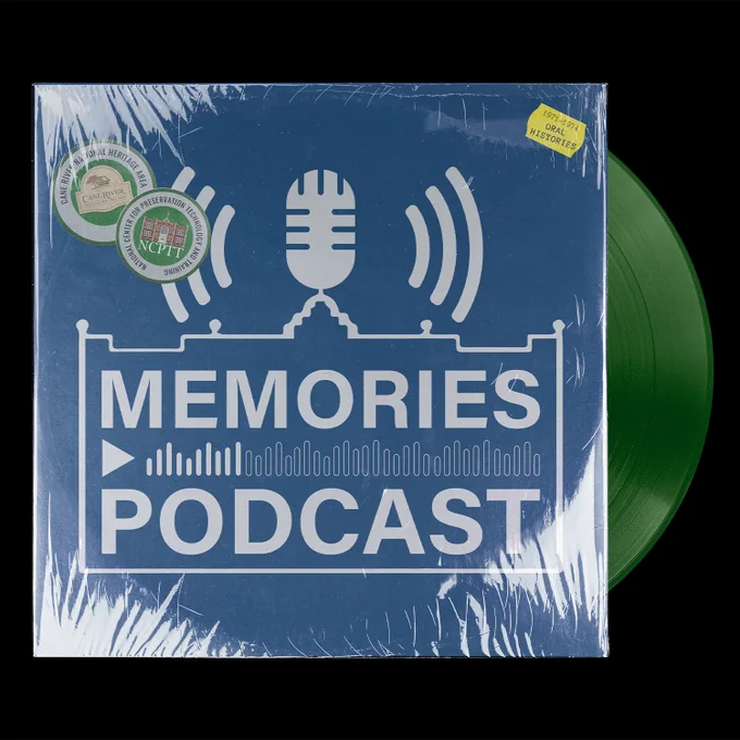 Green vinyl sticking out of a blue vinyl cover with a white microphone image and the words "Memories Podcast" written in white.