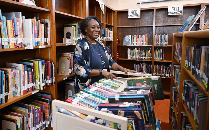 Quinntana Slaughter among library books.