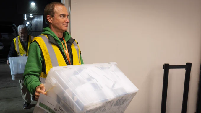 A driver team returns to the Lane County Elections Office with ballots collected from an official ballot drop box in West Eugene.