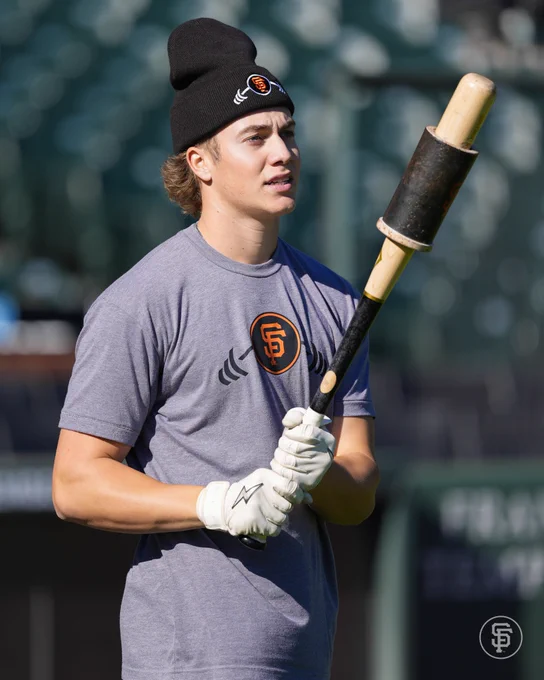 Walker Martin holds a bat while he watches BP