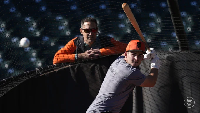 Turner Hill ready to hit as Pat Burrell looks on.