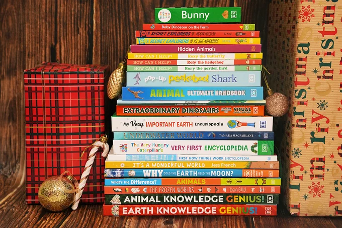 The books being donated by DK next to Christmas presents and tree decorations