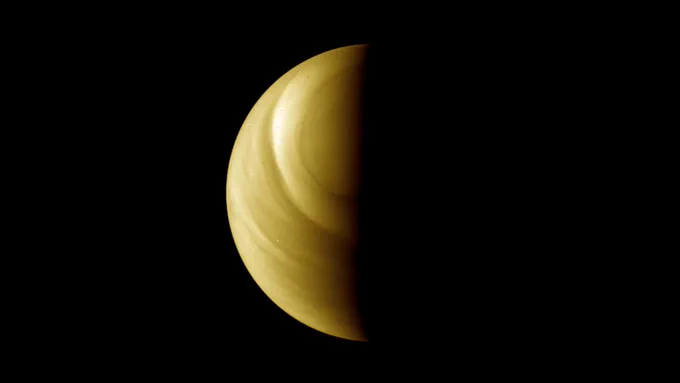 A screenshot from a new animation of an orbit of Venus, taken from data collected by ESA's Venus Express spacecraft. We see planet Venus, half lit.