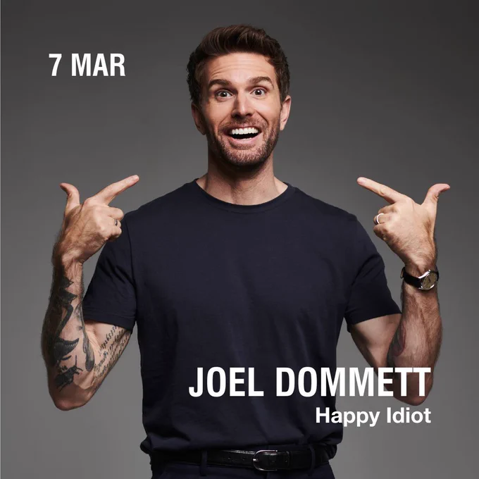 A photo of Joel Dommett. Text reads "Joel Dommett Happy Idiot 7 Mar"
