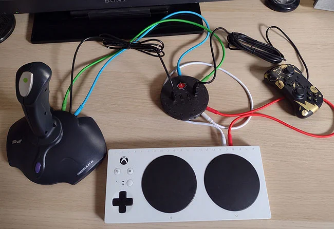 Large joystick with Xbox Adaptive Controller, mini gamepad, coloured patch leads all going into a HID Remapper v6 adapter.