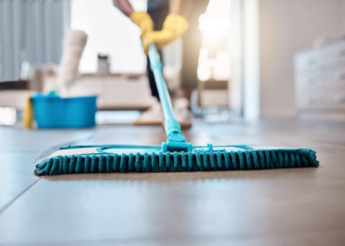 Stock image of cleaner at work, mopping a floor. 