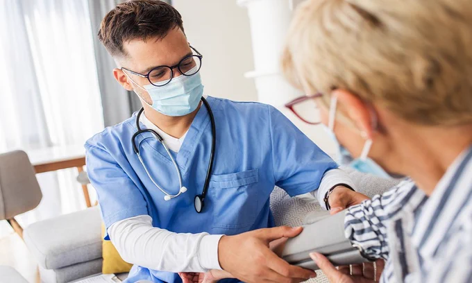 Stock image of health care worker taking a patients blood pressure. 