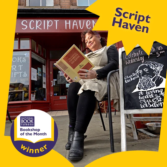 A woman sits in a chair in front of Script Haven Ltd, reading a book.