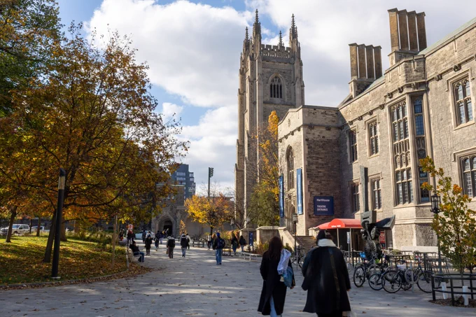 Students walk through the UofT St. George campus during fall. 
