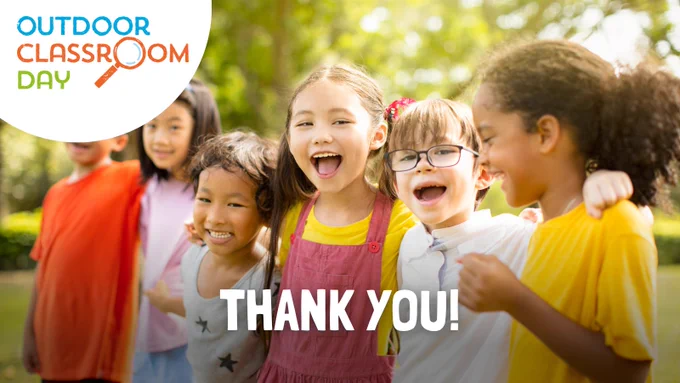 A graphic featuring an image of primary school children in a green outdoor space, smiling and laughing with their arms around each other. The words 'Thank you!' are written in white along the bottom of the image, and the Outdoor Classroom Day logo is overlaid in the top left corner.